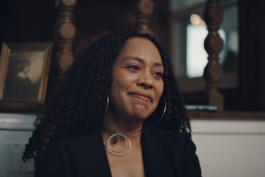 Jacqueline Blocker, person with long dark hair and silver hoop earrings
