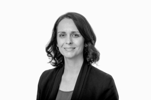 Black and white portrait of Nani Walker, who has shoulder-length hair and is wearing a black blazer.