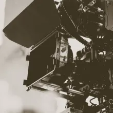 A black and white close up photo of a professional camera.