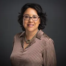 Photograph of Carrie Lozano, a Latinx woman wearing glasses and a patterned shirt. Courtesy of ITVS