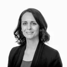 Black and white portrait of Nani Walker, who has shoulder-length hair and is wearing a black blazer.